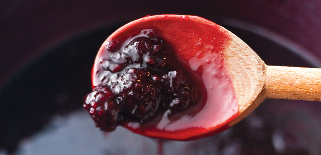 wood spoon with blackberry jam on it